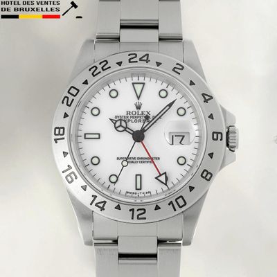 a close up of a watch on a white background with a red second hand