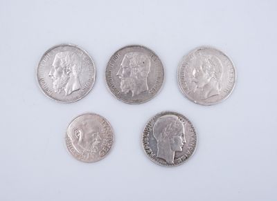 four silver coins are arranged in a row on a white surface