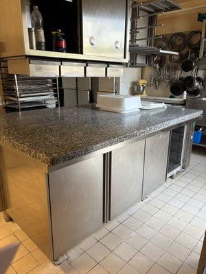 a kitchen with stainless steel cabinets and a granite counter top