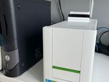 a computer and printer sitting on a shelf next to each other