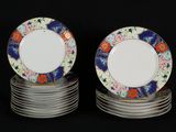 many plates stacked on top of each other on a black surface