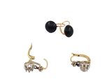 three pairs of earrings with black and white stones on them