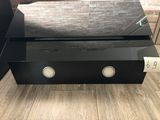 a black coffee table with two speakers on top of it