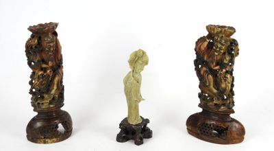 three pieces of carved wood are sitting on top of each other