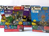 three boxes of k ' nex toys with a ferris wheel in the background