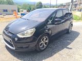 a picture of a small black car parked in a lot