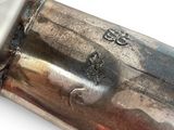 a close up of a metal pipe on a white surface