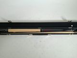 two pens and a pencil in a case on a table