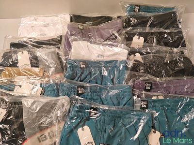 several pairs of underwear are wrapped in plastic bags on a shelf