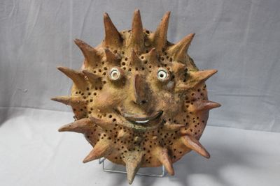 a sculpture of a sunflower with a face made out of it