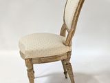 an image of a white chair with a beige upholstered seat