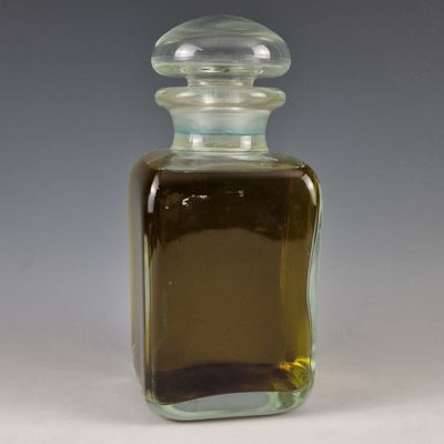 a small glass bottle with a brown liquid inside of it