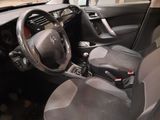 the interior of a small car with a steering wheel and dashboard