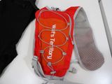 a red backpack and a pair of shoes sitting on a table