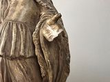 a statue of a woman holding a bird in her hand