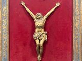 an image of a gold crucif on a red background