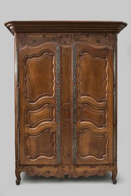 an antique wooden armoire with ornate carvings on the doors