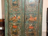 une armoire verte ornée d'un tableau, dans une pièce