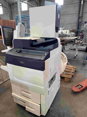 a printer that is sitting on a table in a warehouse