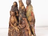 an image of a statue of a group of people sitting on a tree stump