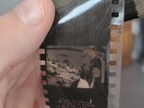 a person holding a film strip with a picture on it