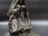 statue of a woman holding a child on a rock