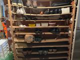 a wooden shelf with many pairs of shoes on top of it
