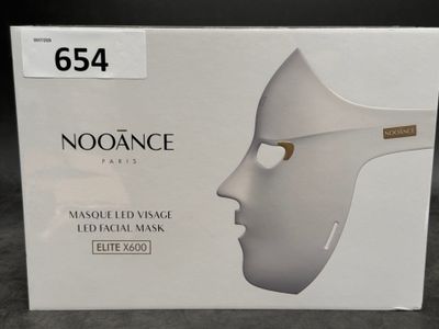 a box with a white mask on it on a table
