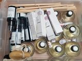 a plastic container filled with different types of crafting supplies