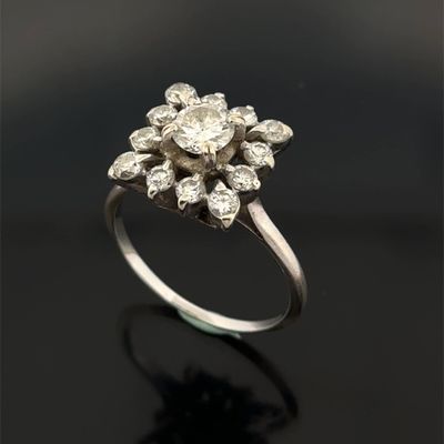 a close up of a diamond ring on a black surface