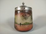 a small jar with a painting on it sitting on a table