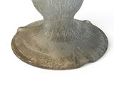 a glass vase sitting on top of a wooden stand