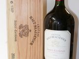 a bottle of wine sitting next to a wooden box