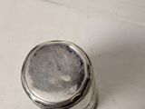 a silver salt and pepper shaker sitting on a counter