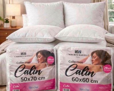 two pillows on a bed with a woman ' s face on them