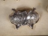 a silver plate with a design on it on a table