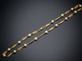a pair of gold and pearl bracelets