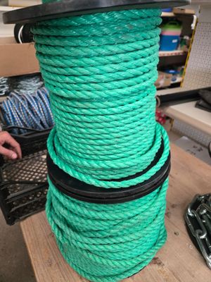 un gros plan sur un tas de corde verte posé sur une table