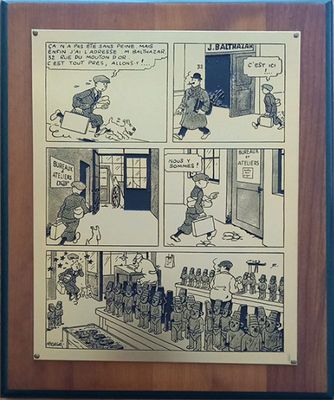 Une vieille bande dessinée est accrochée au mur d'une pièce.