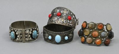 three silver bracelets and a ring with turquoise, coral and coral stones