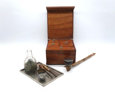 une petite boîte en bois sur laquelle sont posés une bouteille et une cuillère