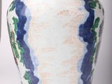 two vases sitting next to each other on a white surface