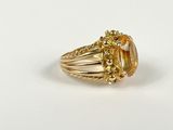 a close up of a gold ring with a citrine stone