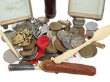 a lot of coins and a knife on the table