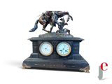 a statue of a man riding a horse with a clock on it