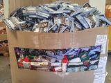 a cardboard box full of candy and candy bars on a pallet