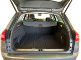 the back of a car with its trunk open and the back seats folded down