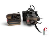 two old polar cameras sitting next to each other on a white surface