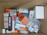 a cardboard box full of electronic devices and other items