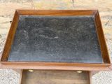a small wooden table with a black granite top